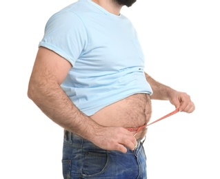 Photo of Overweight man with measuring tape on white background