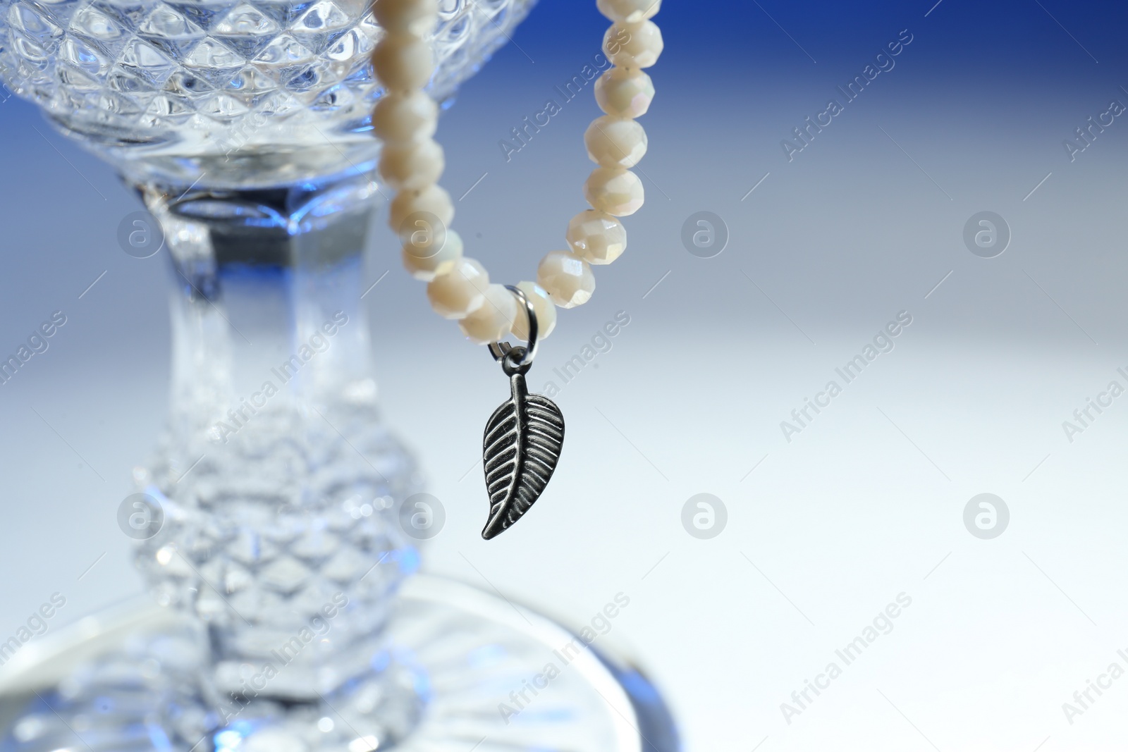 Photo of Stylish presentation of elegant pearl necklace on color background, closeup. Space for text