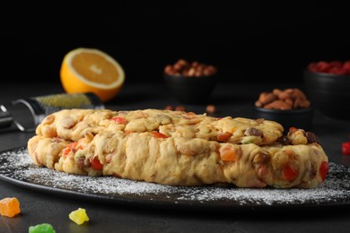 Unbaked Stollen with candied fruits and raisins on grey table, closeup