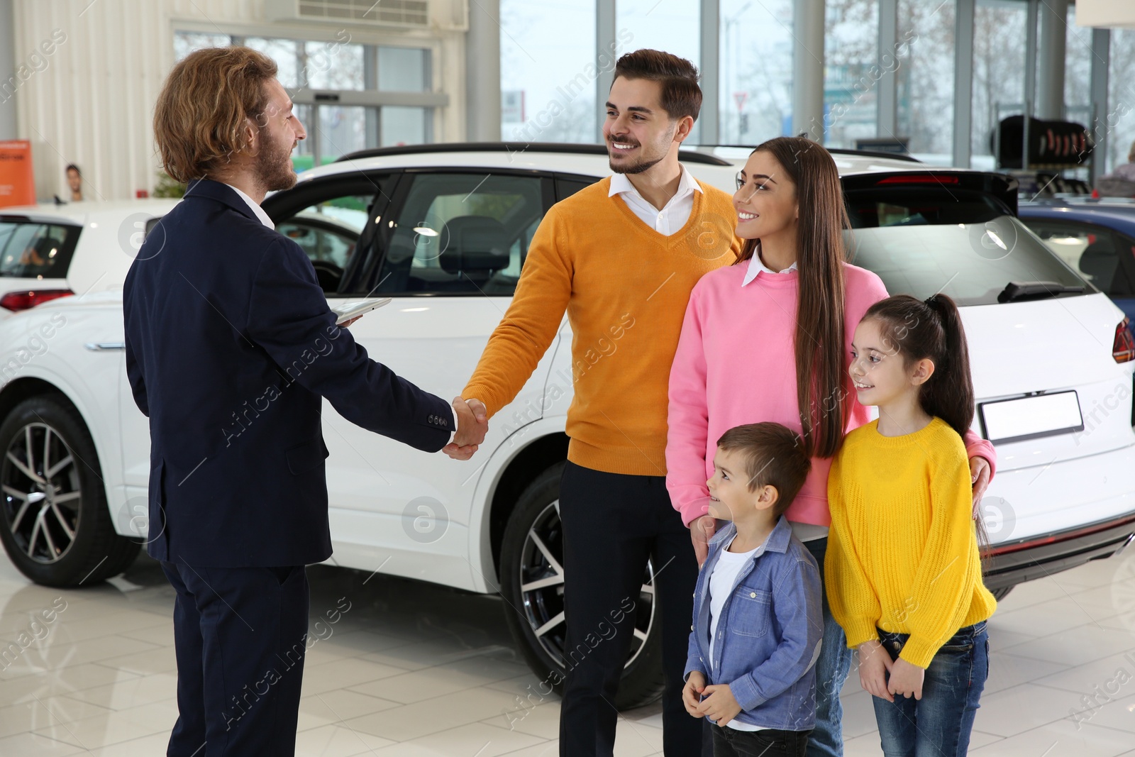 Photo of Car salesman working with family in dealership