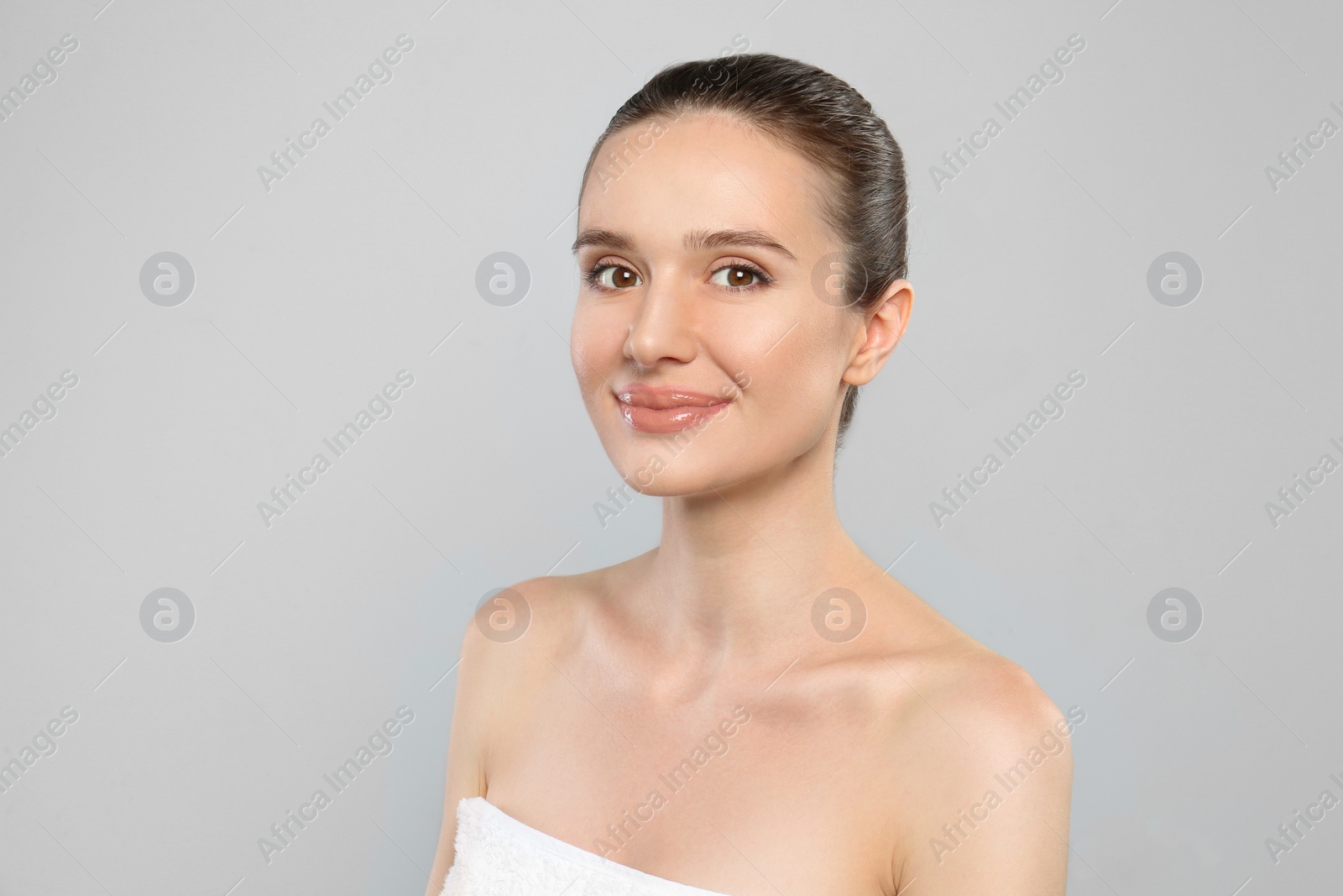 Photo of Portrait of beautiful young woman with perfect skin on grey background. Spa treatment