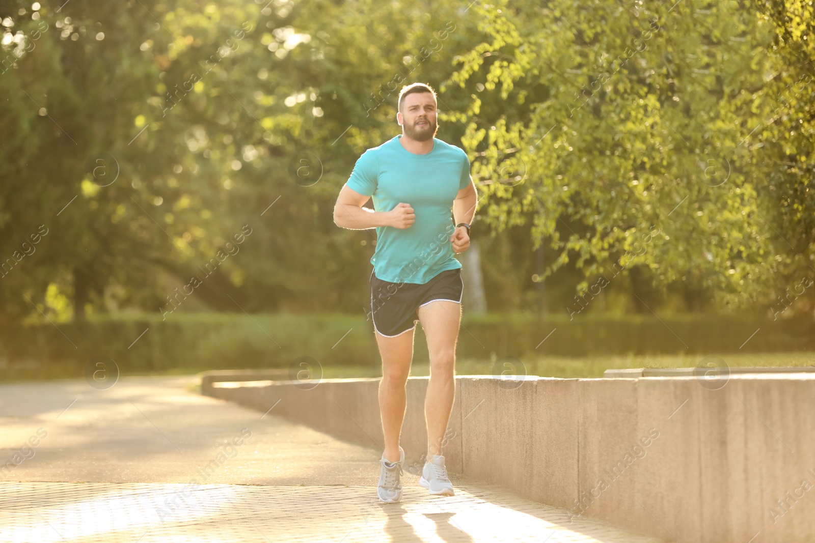 Photo of Young man running in park on sunny day