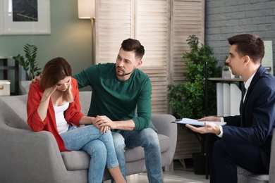 Photo of Young couple with problem at family psychologist office