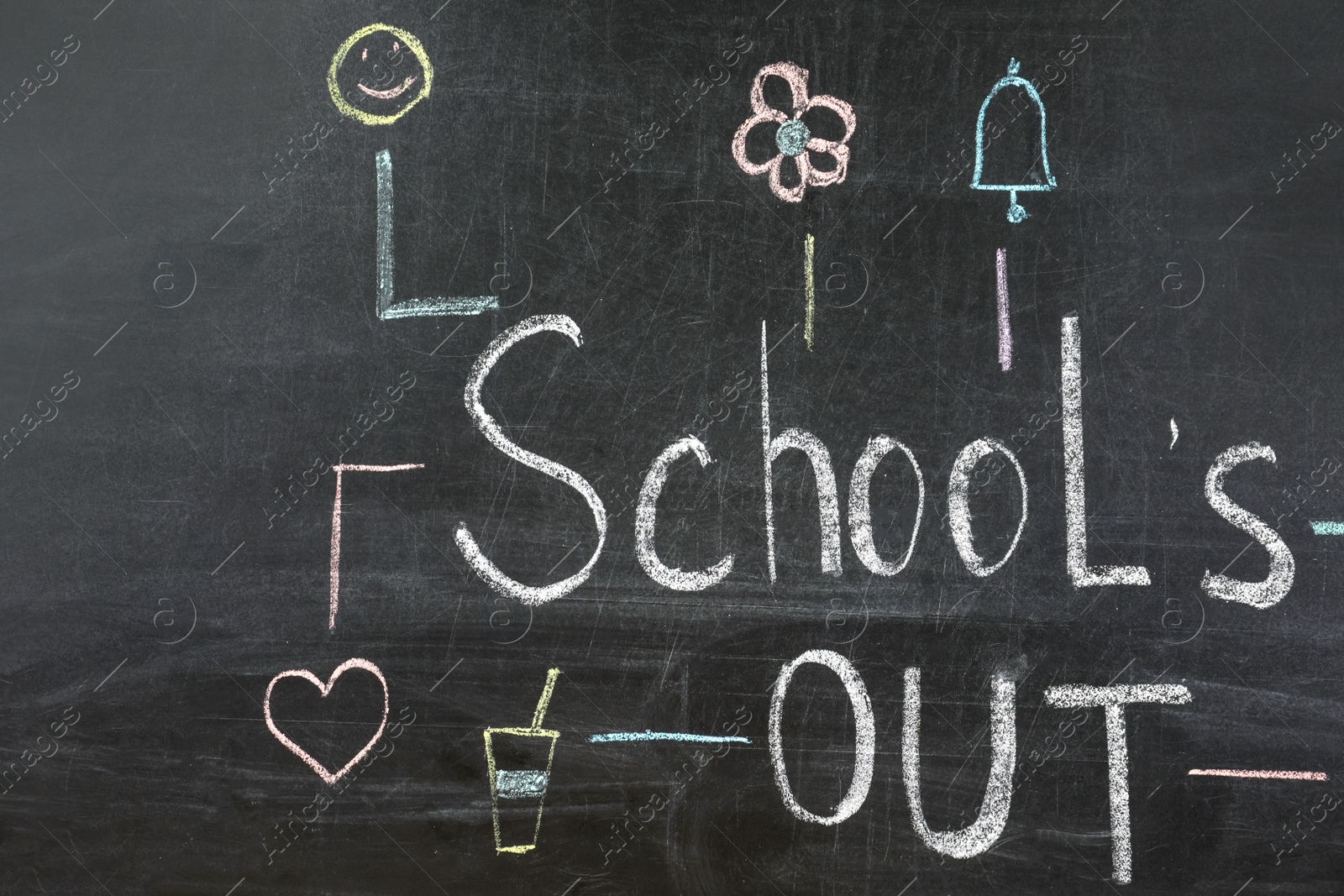 Photo of Text School's Out and drawings on black chalkboard. Summer holidays