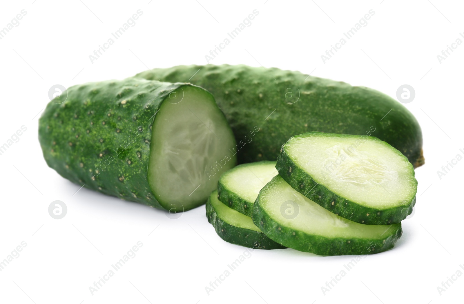 Photo of Whole and cut cucumbers on white background