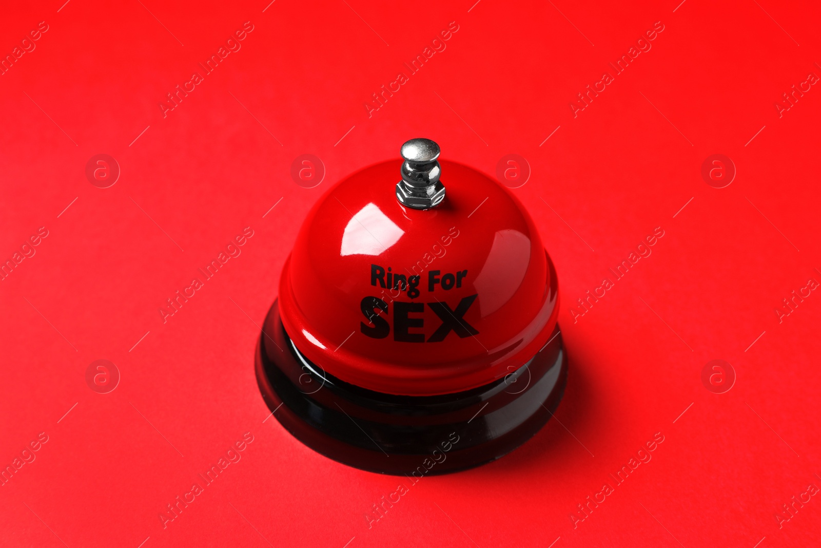 Photo of Sex bell on red background. Erotic role play