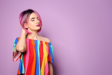 Photo of Young woman with trendy hairstyle against color background