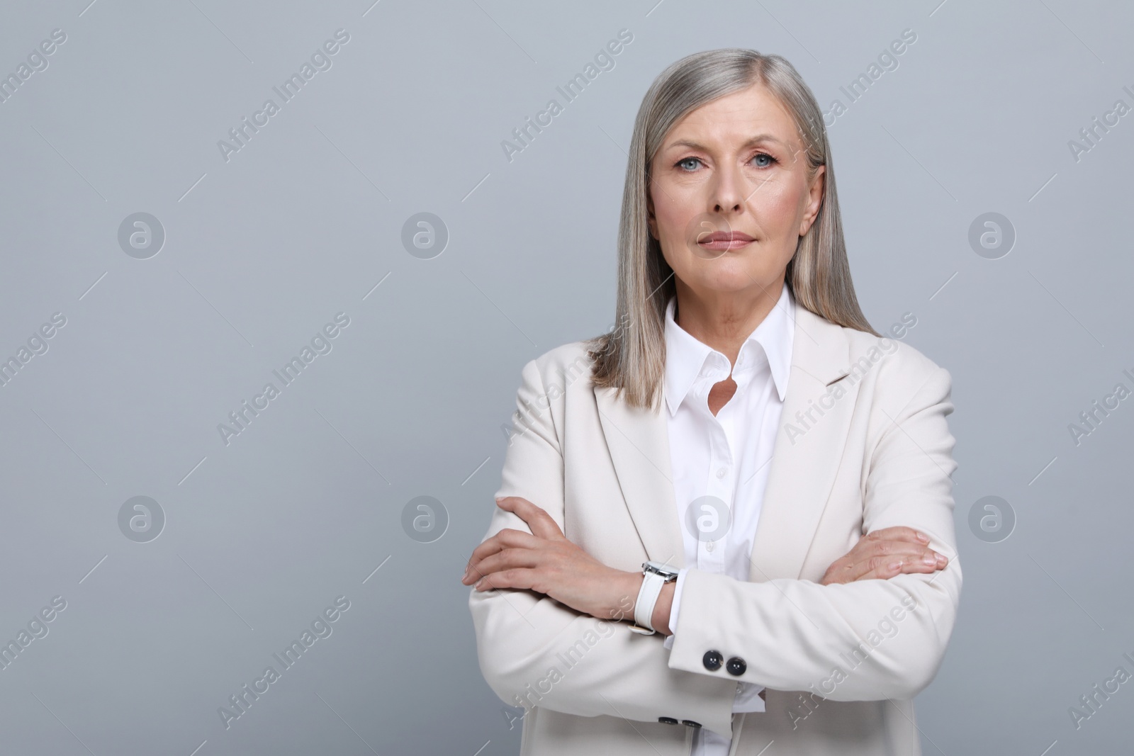 Photo of Portrait of beautiful senior woman on grey background. Space for text