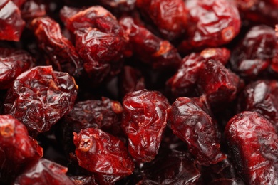 Photo of Pile of tasty dried cranberries as background, closeup