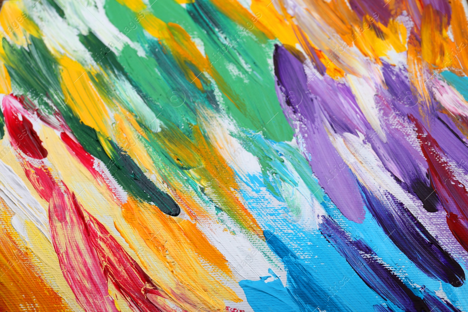 Photo of Beautiful strokes of colorful oil paints on white canvas as background, closeup