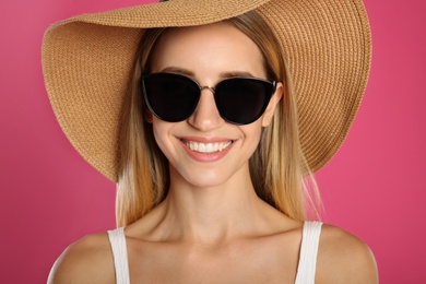 Photo of Beautiful woman in stylish sunglasses on pink background