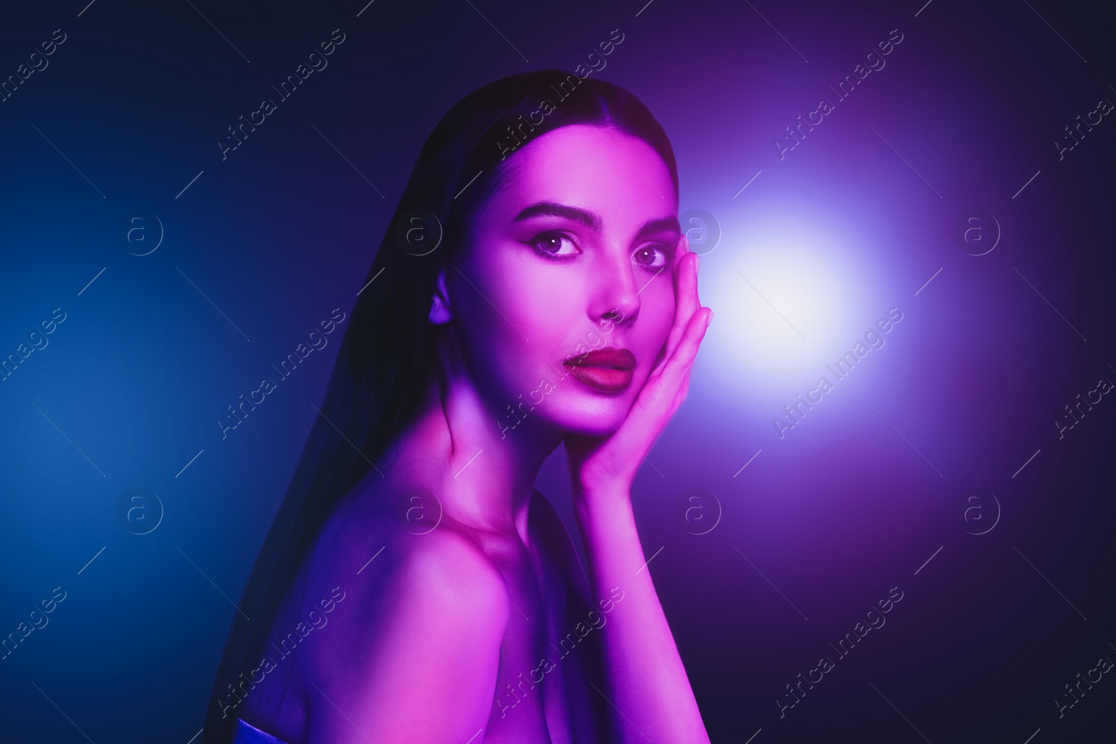 Image of Portrait of beautiful woman in neon lights