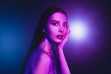 Image of Portrait of beautiful woman in neon lights