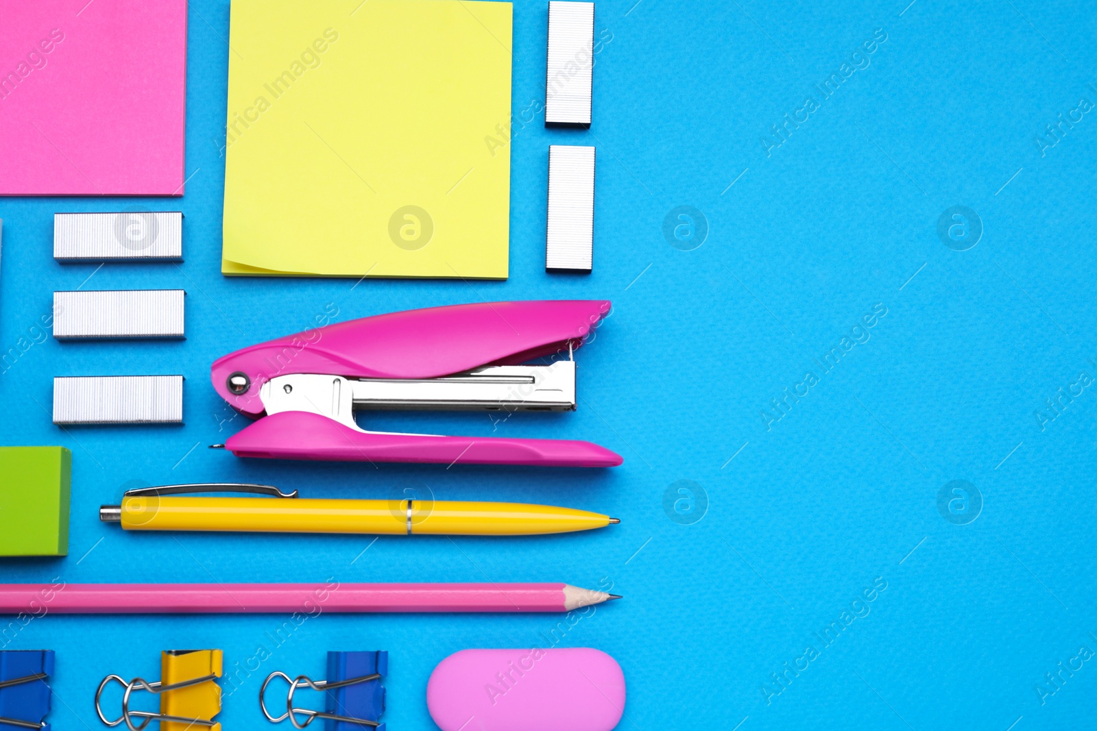 Photo of Flat lay composition with new stapler on light blue background, space for text