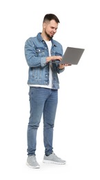 Photo of Man in denim clothes using laptop isolated on white