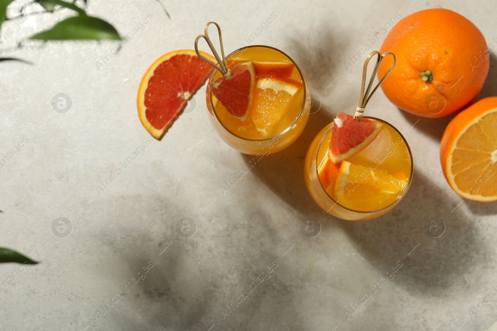 Photo of Delicious orange soda water on light table, flat lay. Space for text