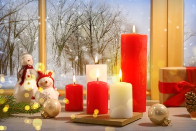 Burning candles and festive decor on window sill indoors. Christmas eve