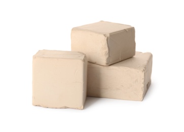 Photo of Blocks of compressed yeast on white background