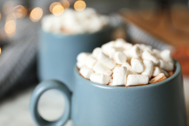 Photo of Delicious cocoa drink with marshmallows on table, closeup