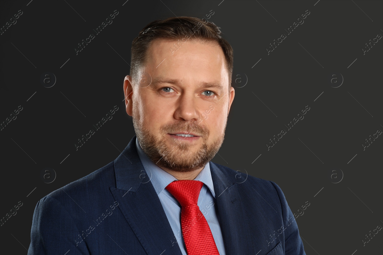 Photo of Portrait of mature man on black background