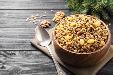 Photo of Traditional Christmas slavic dish kutia on black wooden table, closeup. Space for text