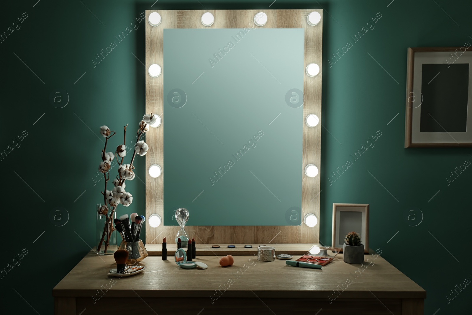 Photo of Decorative cosmetics and tools on dressing table near mirror in makeup room