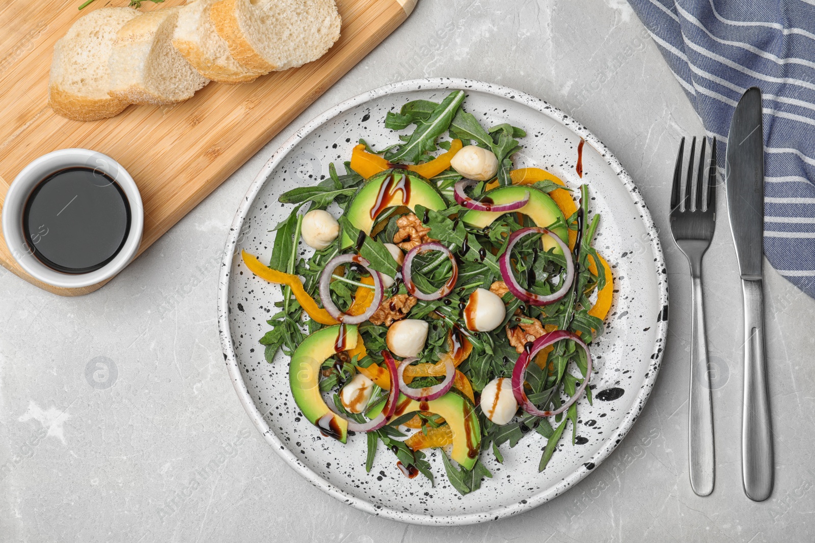 Photo of Fresh vegetable salad and balsamic vinegar served on table, top view