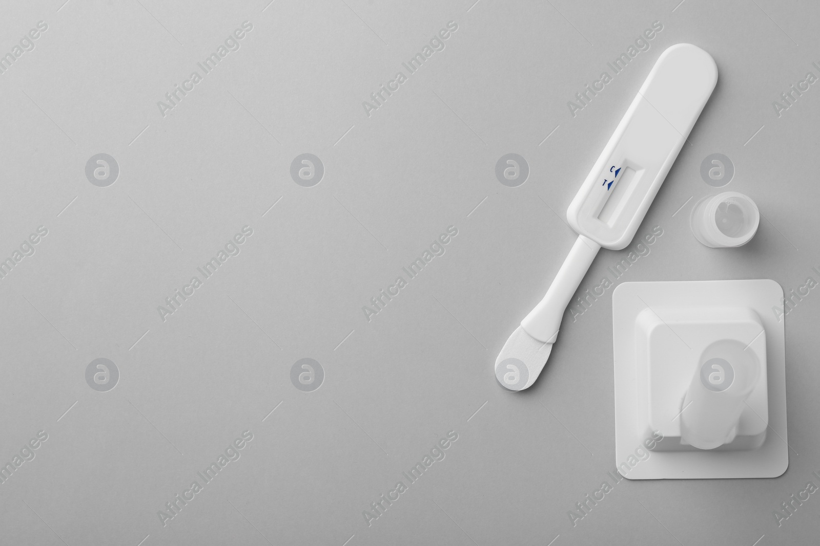 Photo of Disposable express test kit on light grey background, flat lay. Space for text