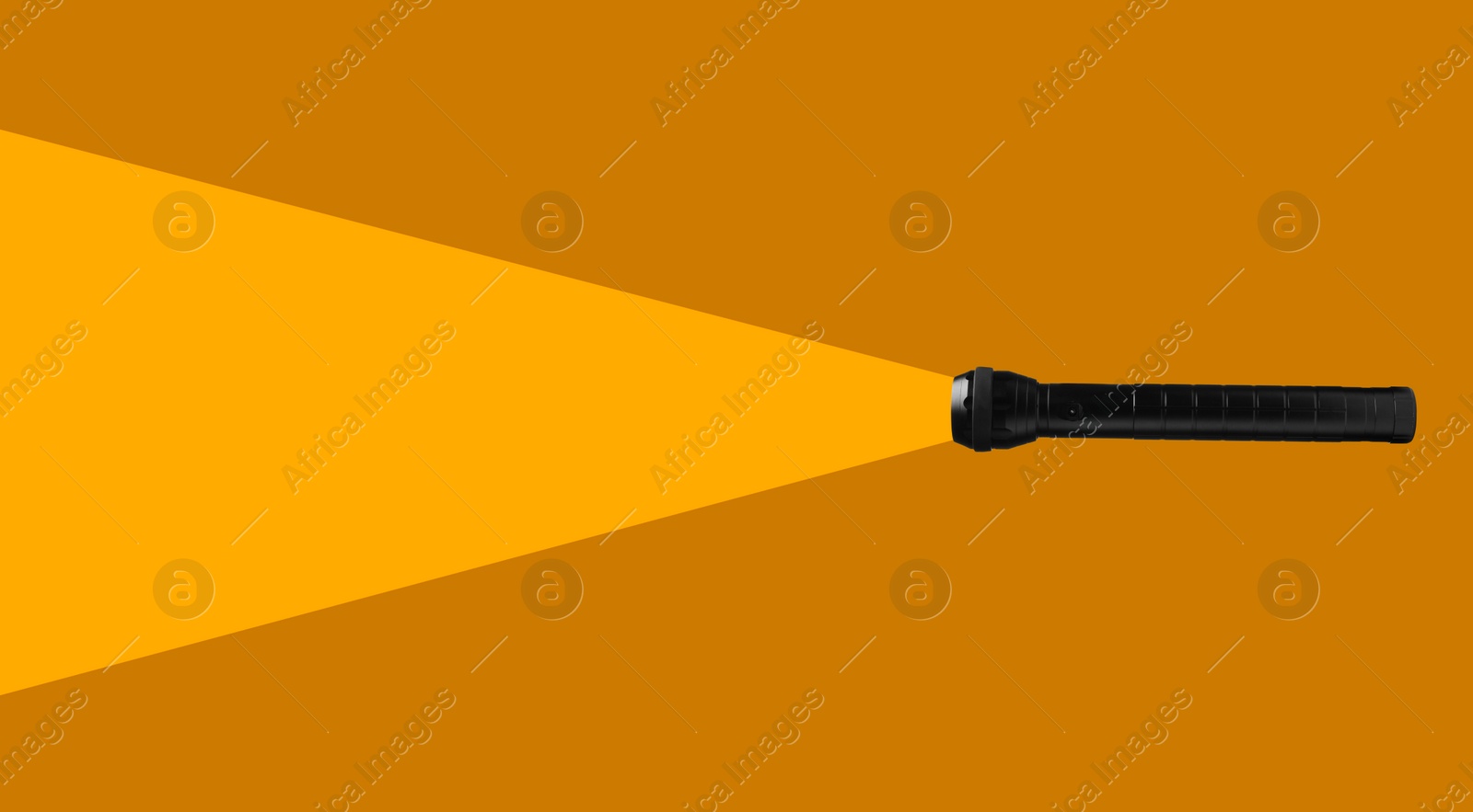 Image of Flashlight illuminating orange background. Light symbolizing search, guidance, direction and other