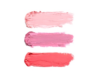 Photo of Strokes of lipstick on white background, top view