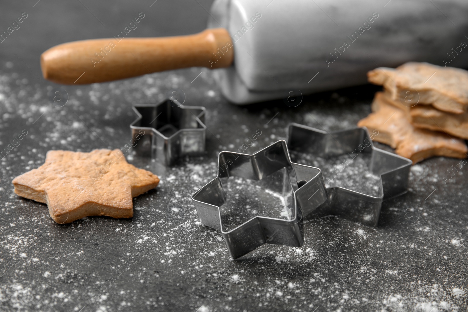 Photo of Tasty homemade Christmas cookies and cutters on table