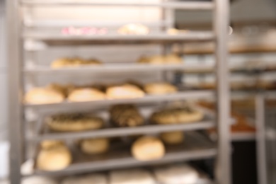 Photo of Blurred view of rack with pastries in workshop