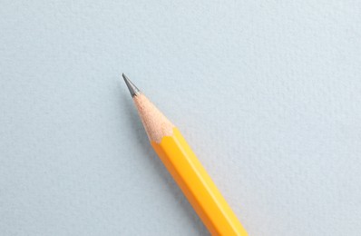 Photo of One sharp graphite pencil on white background, top view