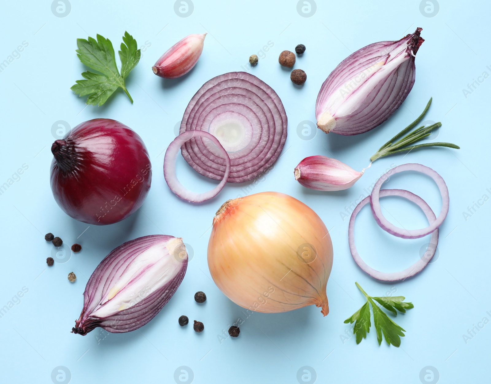 Photo of Flat lay composition with onion and spices on light blue background