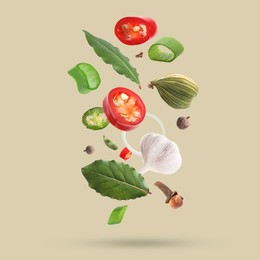 Image of Different spices falling on dark beige background