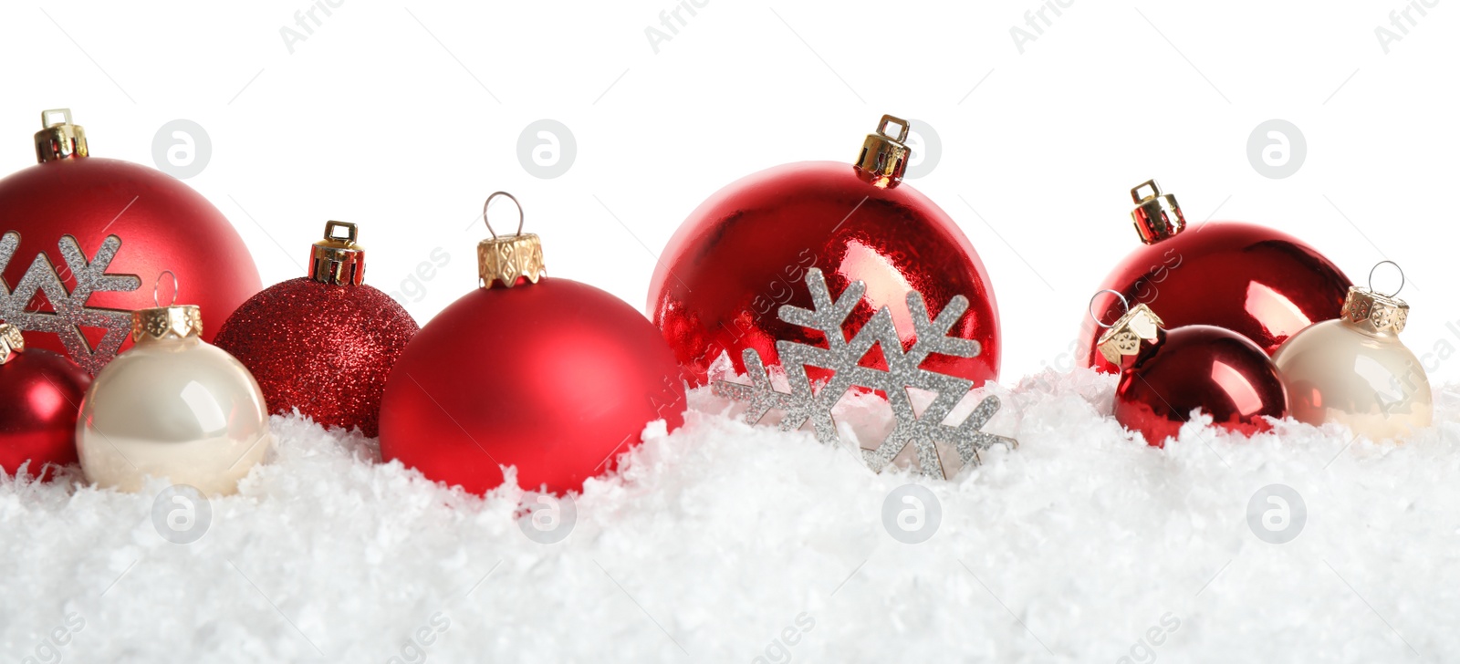 Photo of Christmas tree decoration on artificial snow against white background