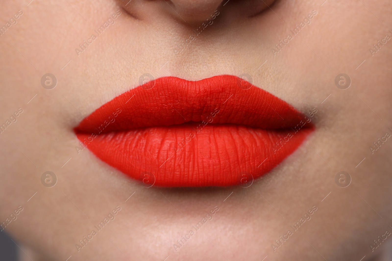 Photo of Young woman with beautiful red lips, closeup