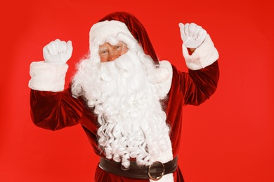 Photo of Happy authentic Santa Claus on red background