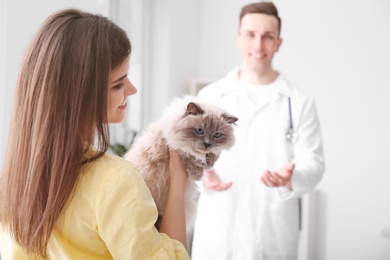 Photo of Young woman with cat in veterinarian clinic