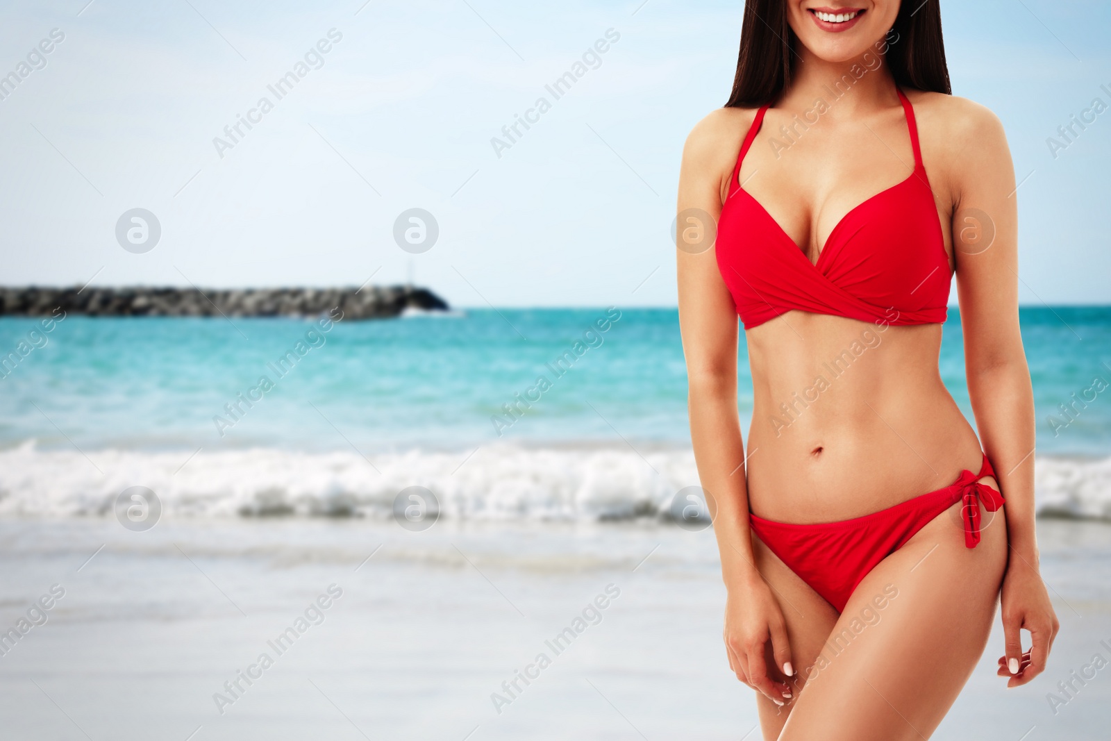 Image of Pretty sexy woman with slim body in stylish bikini at beach, closeup. Space for text