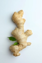 Photo of Fresh ginger with green leaves on white background, top view