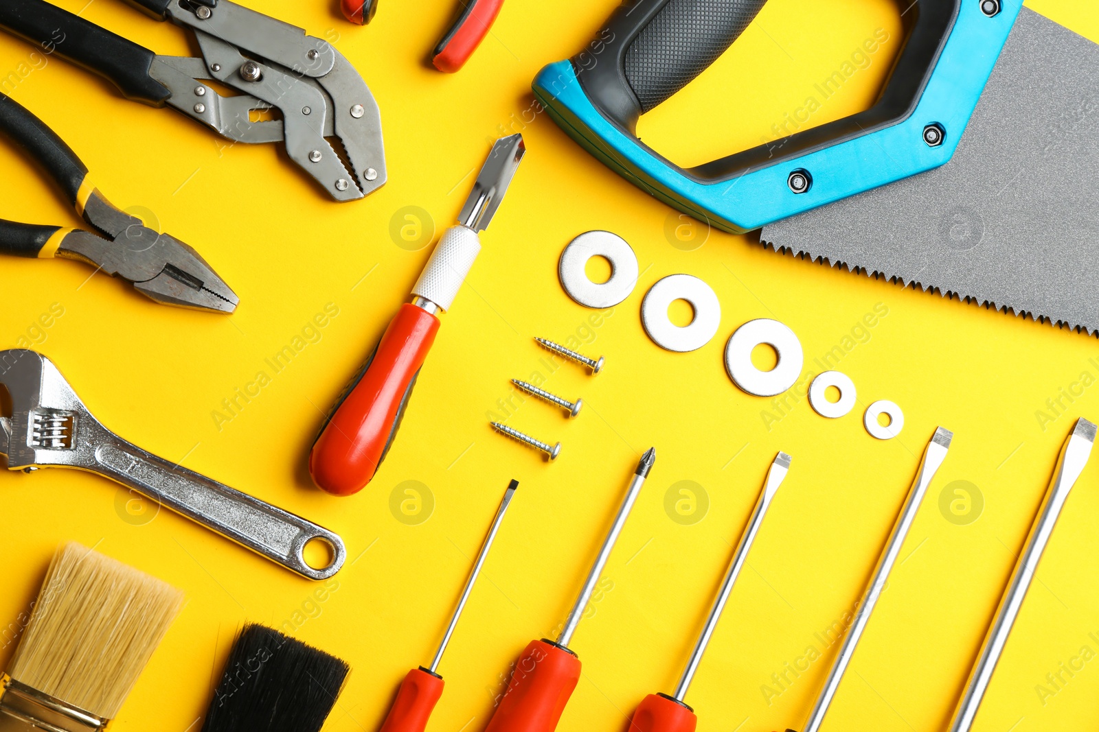 Photo of Flat lay composition with construction tools on color background