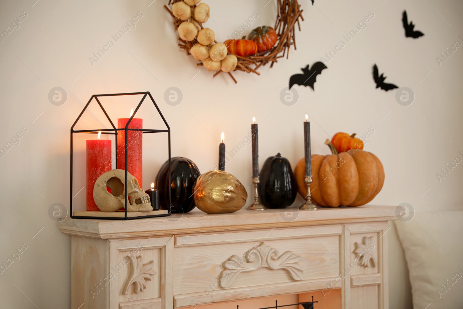 Photo of Fireplace and Halloween decor in room. Idea for festive interior