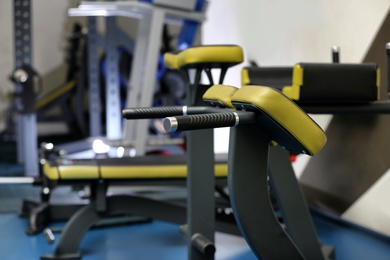 Photo of Back extension machine in gym, closeup. Modern sport equipment