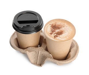 Takeaway paper cups with coffee in cardboard holder on white background