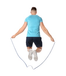 Sportive man training with jump rope on white background
