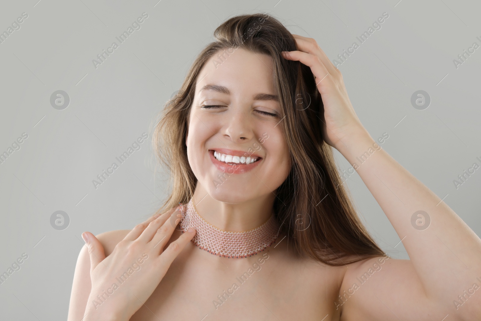 Photo of Portrait of beautiful young woman on grey background