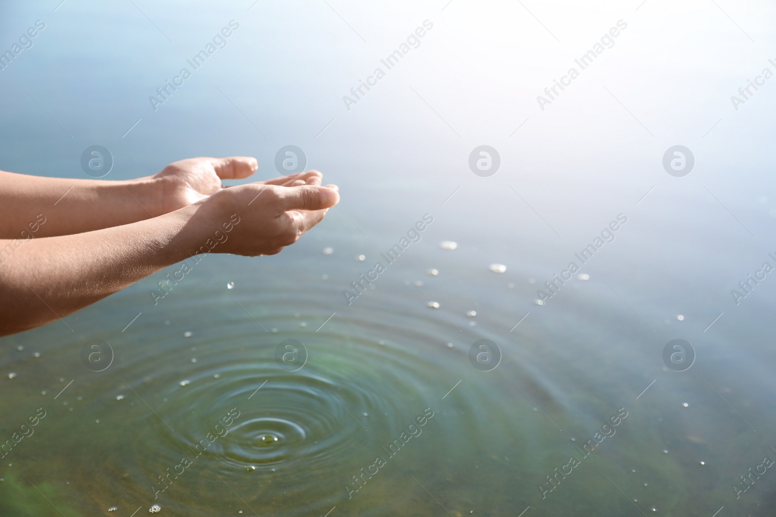 Photo of Woman taking pure water from river, closeup. Nature healing power