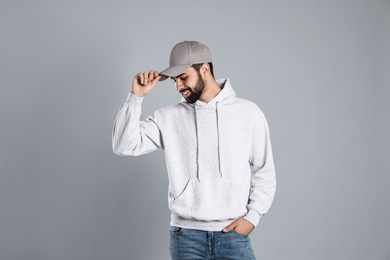 Portrait of young man in sweater on grey background. Mock up for design