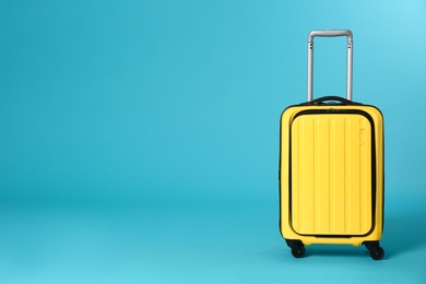 Stylish suitcase on color background. Space for text